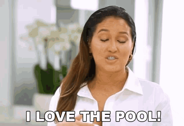 a woman is saying i love the pool in a white shirt