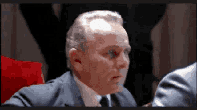 a man in a suit and tie looks at something