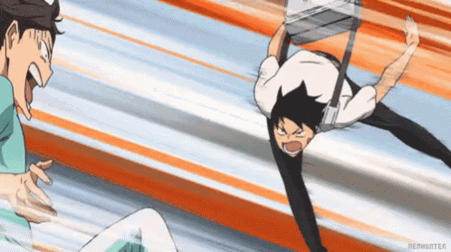 a man is flying through the air while another man is standing next to him .