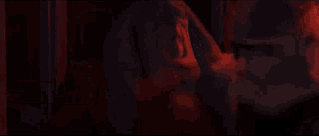 a close up of a storm trooper holding a gun in a dark room