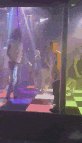 a blurry picture of people dancing in a night club