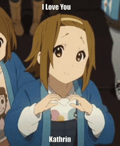 a girl in a blue jacket is making a heart with her hands and says " i love you kathrin "