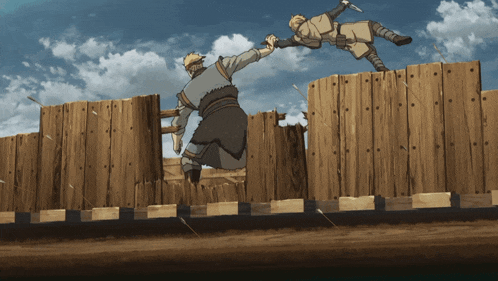 two men are jumping over a wooden fence and one is holding another man 's hand