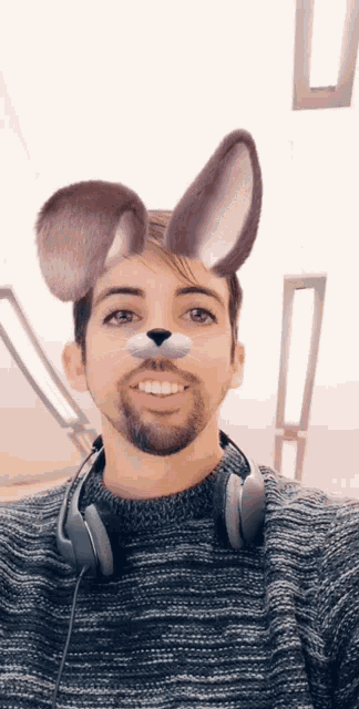 a man wearing headphones and a bunny mask
