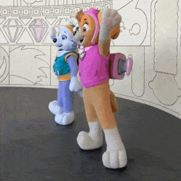 skye and everest from paw patrol are standing next to each other on a stage