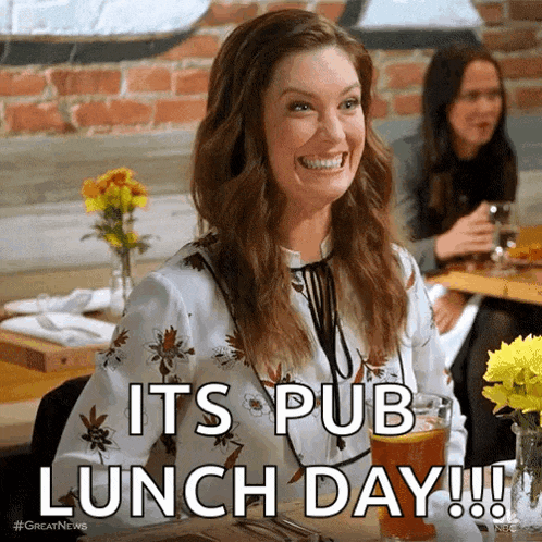 a woman is sitting at a table with a glass of beer and the words it 's pub lunch day !