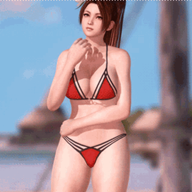 a woman in a red bikini stands on the beach