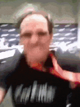 a blurry picture of a man wearing a black shirt that says ' california ' on it