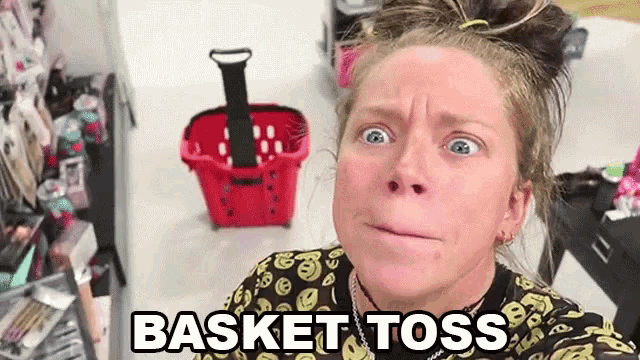 a woman is making a face in front of a red basket that says basket toss on it