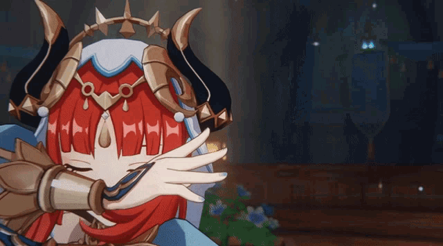 a girl with red hair is covering her face with her hand