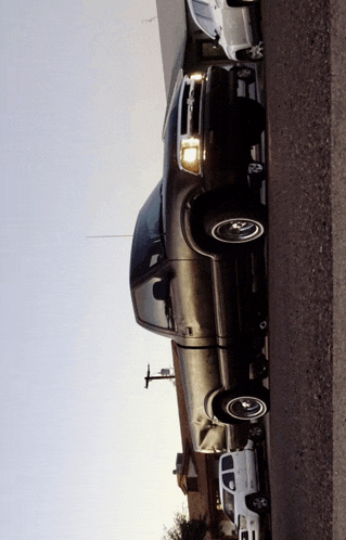 a black truck is parked on the side of a road