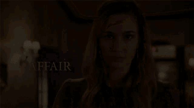 a woman stands in front of a sign that says " affair "