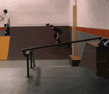 a skateboarder is doing a trick on a railing with a helmet that says exir on it