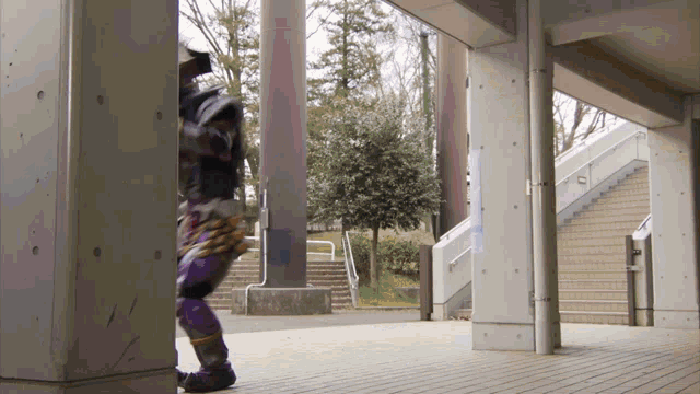 a person in a purple and gold costume is walking through a hallway