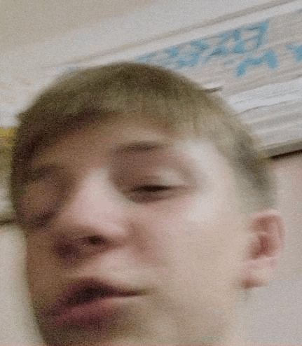 a close up of a man 's face with his eyes closed and his mouth open .