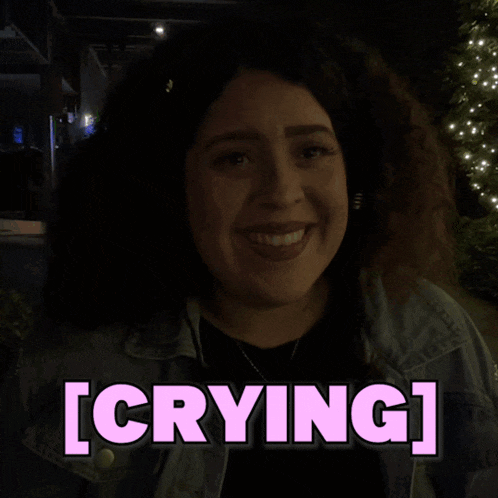 a woman in a dark room with the word crying above her