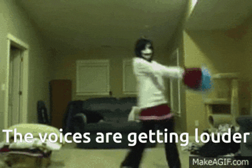a woman in a mask is dancing in a living room with the words " the voices are getting louder " written below her