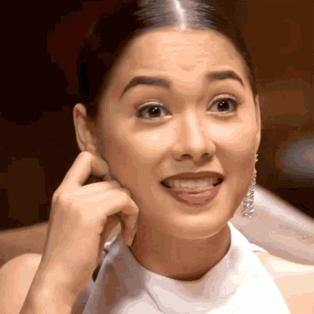 a woman with a surprised look on her face holds her hand to her face