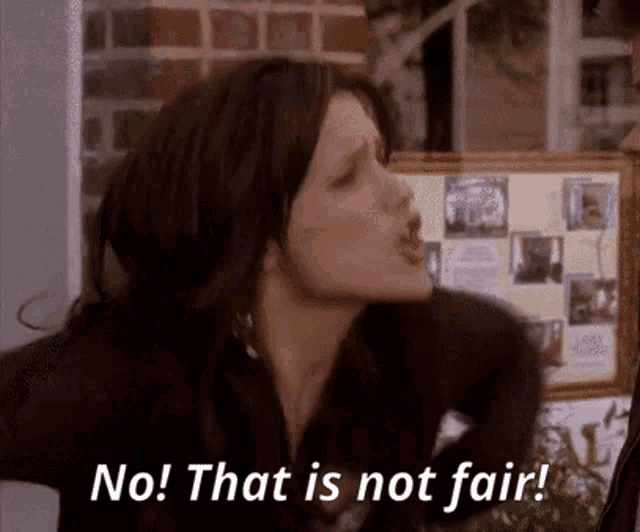 a woman says " no that is not fair " in front of a framed picture