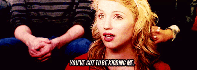 a woman says you 've got to be kidding me while sitting in a crowd
