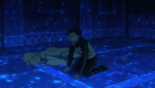 a man is kneeling next to a woman laying on the floor