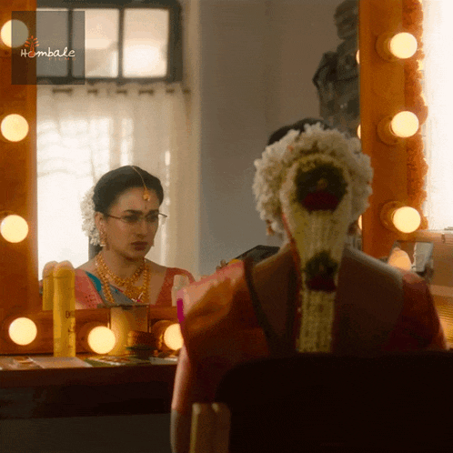 a woman is looking at herself in a mirror with the word hembale on the bottom
