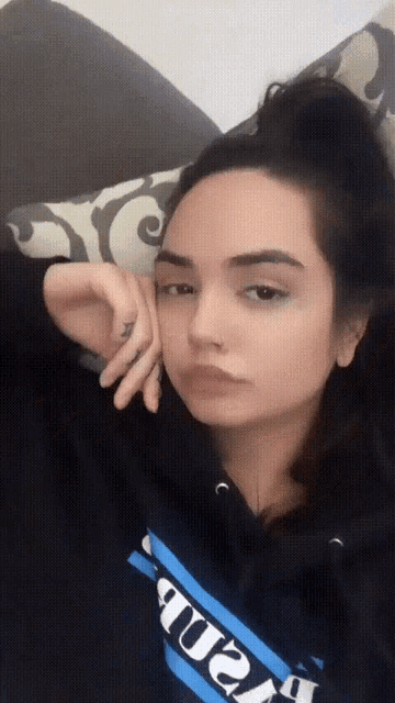 a woman wearing a black hoodie with the word ' amanda ' on it