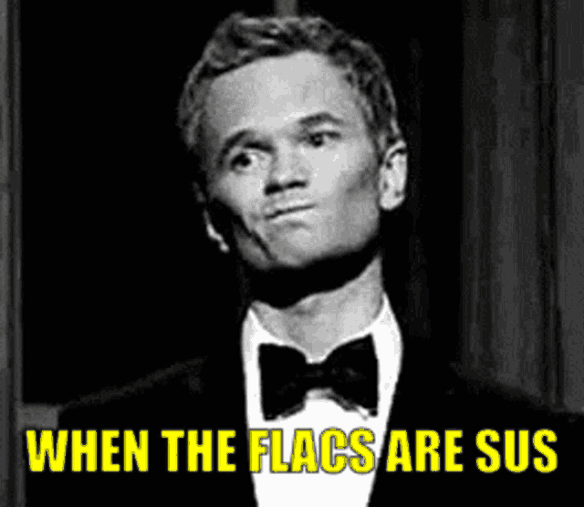 a man in a tuxedo and bow tie is saying when the flags are sus .