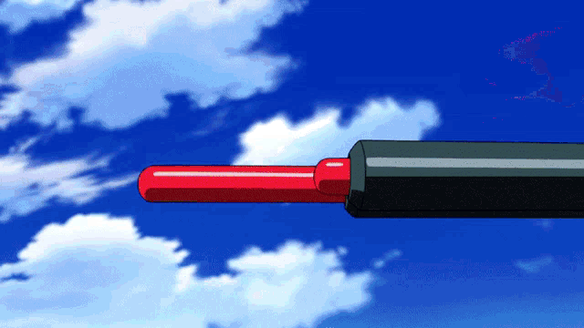 a red and black object against a blue sky with white clouds