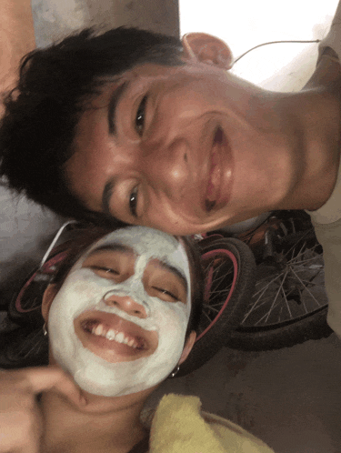 a man and a woman with white face masks on