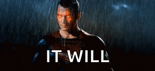 a man in a superhero costume is standing in the rain with the words `` it will '' behind him .