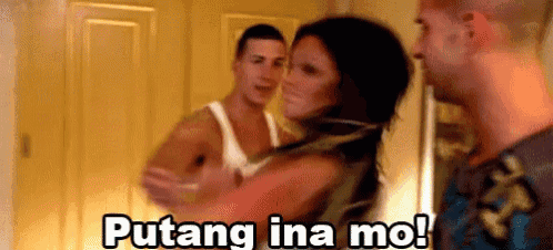 a man and a woman are standing next to each other in a room and the man is holding the woman .