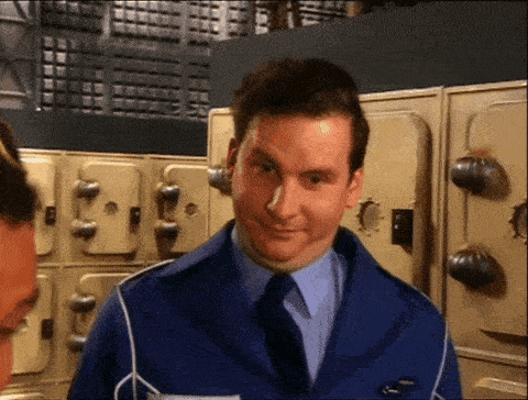 a man in a blue uniform is smiling in front of a row of lockers