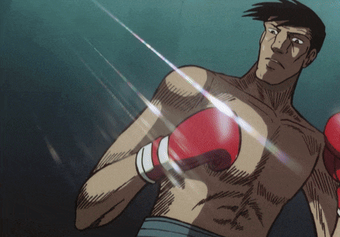 a shirtless boxer with red boxing gloves on