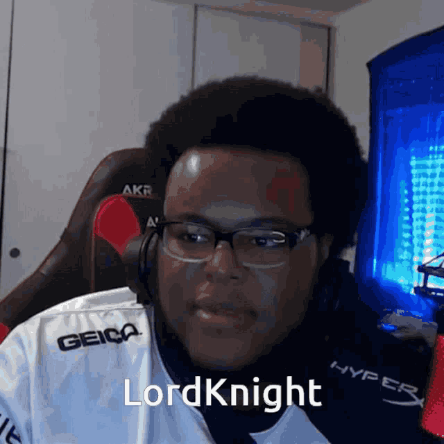 a man wearing glasses and headphones with the name lord knight on his shirt