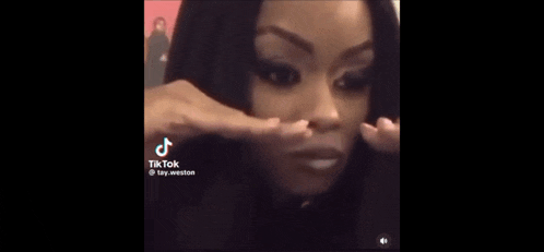 a tiktok video of a woman covering her nose with her hands