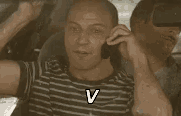 a man is talking on a cell phone in a car and making a funny face .