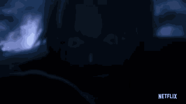 a blurred image of a person 's face with a netflix logo in the corner