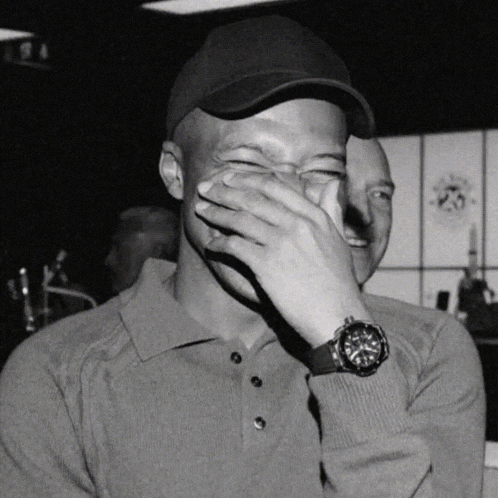 a man wearing a watch is covering his face