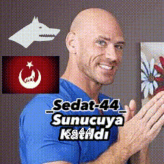 a bald man in a blue shirt is smiling in front of a picture of a wolf and a flower