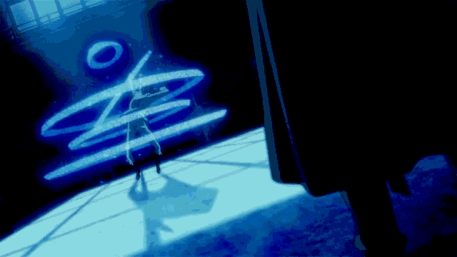 a person is standing in front of a blue sign that says ' o '