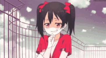 a girl with pigtails and a red shirt is smiling and crying