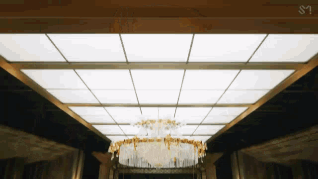 a chandelier is hanging from the ceiling of a building