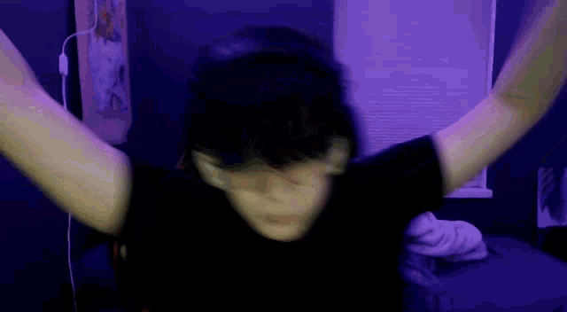 a person with their arms outstretched and a black shirt on