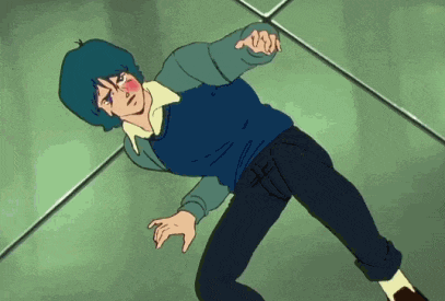 a man with blue hair is laying on the floor with his hand on his face