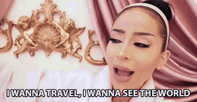 a woman is singing i wanna travel i wanna see the world .