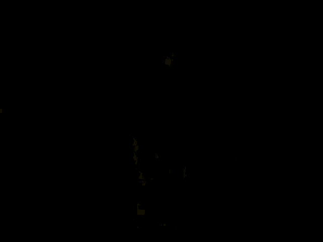 a man in a black shirt with a star on the collar is smiling while sitting at a table .