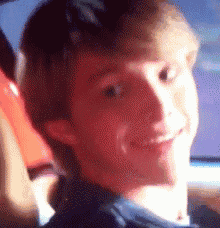 a close up of a young man 's face with a blurred background