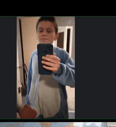 a young boy is taking a selfie with a cell phone
