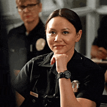 a woman in a police uniform has the name owen on her shirt